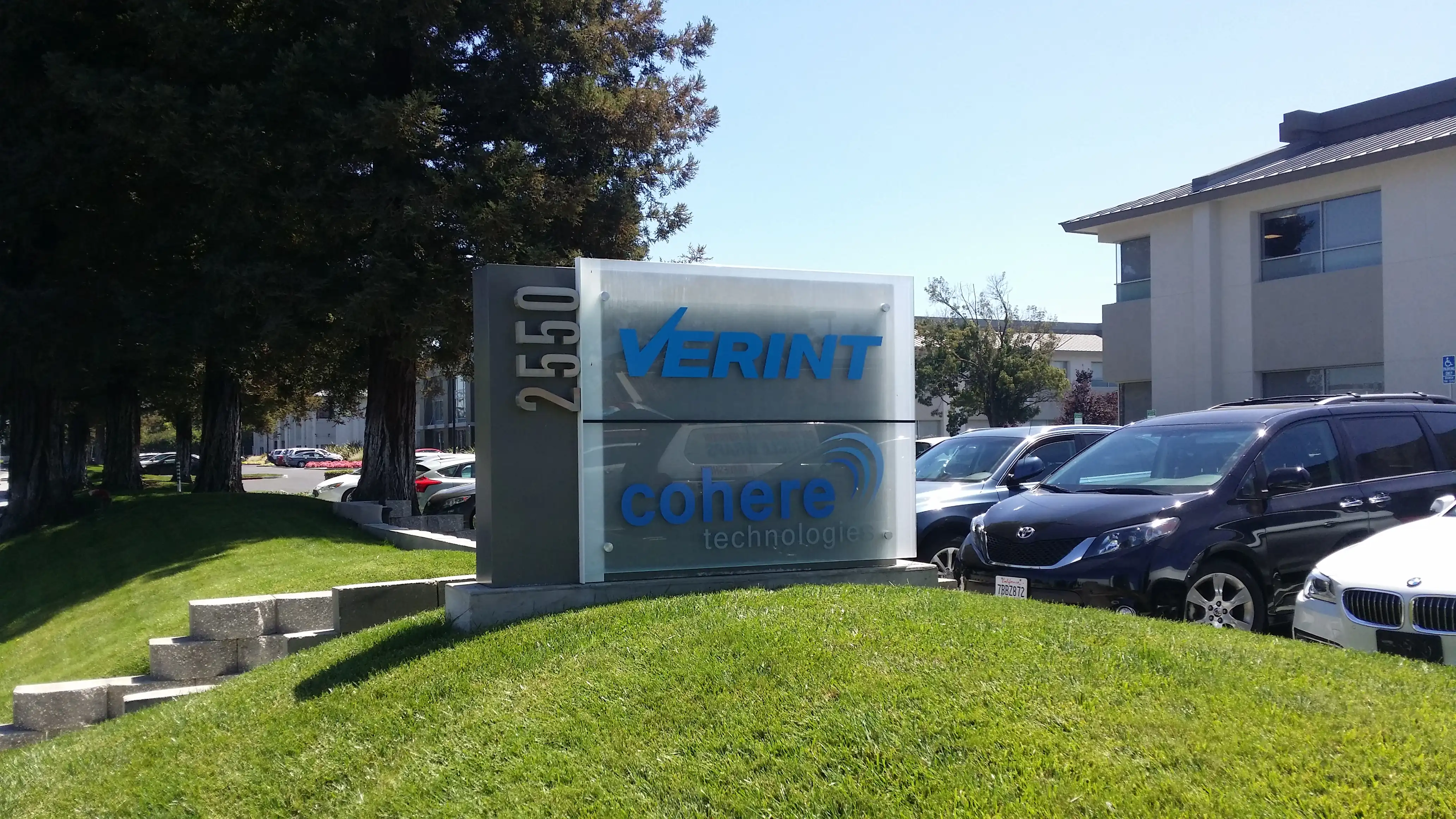 Cohere Technologies multi-tenant monument sign — printed vinyl on acrylic panel with standoffs, San Jose