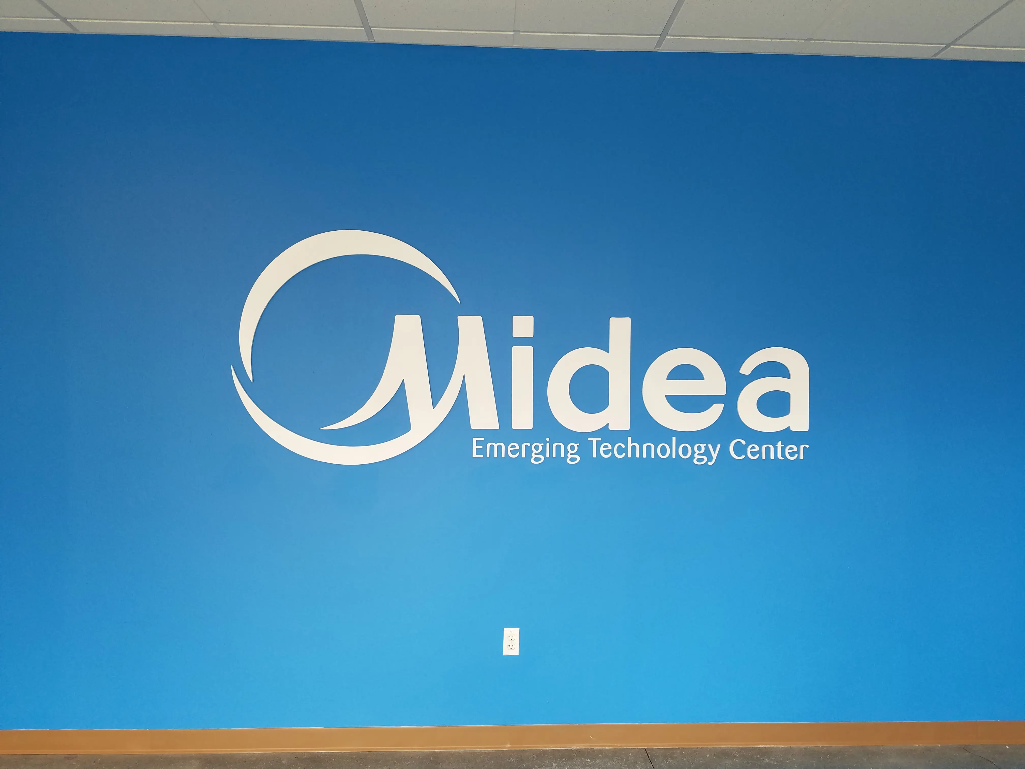 Midea Emerging Technology Center white dimensional letters on blue wall