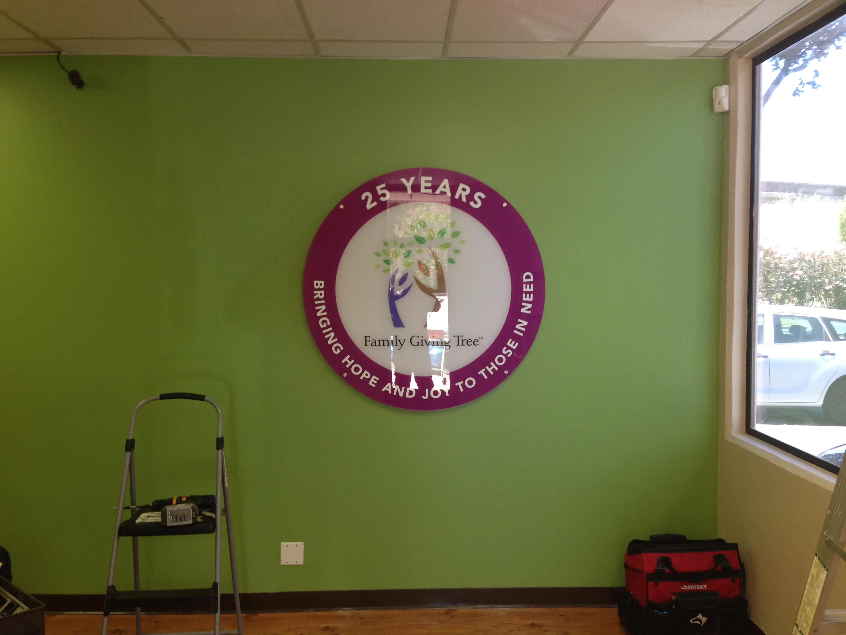 Family Giving Tree round acrylic lobby sign — Clear Line Signs