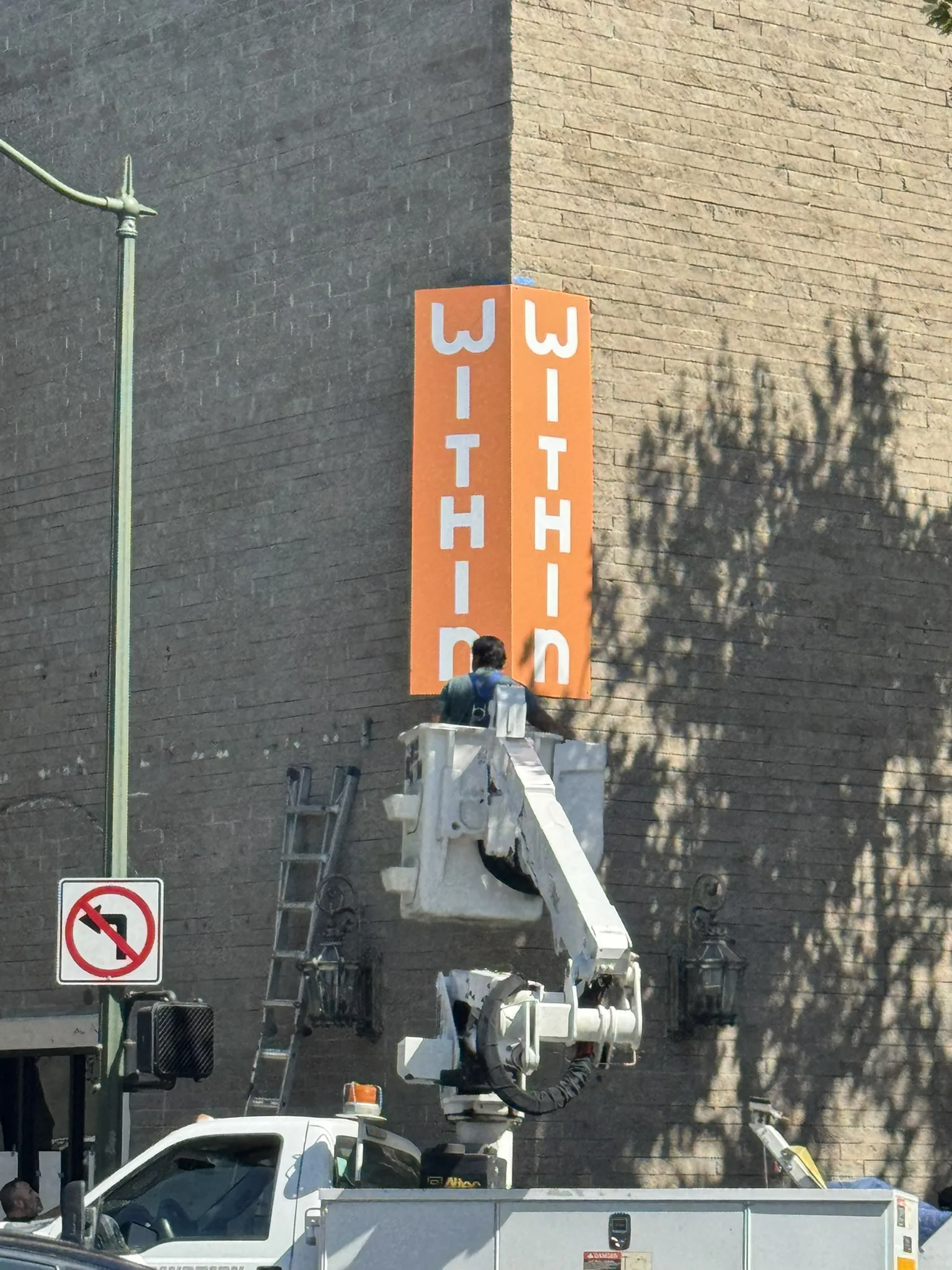 Corner blade sign installation on brick building — Within — Clear Line Signs Palo Alto
